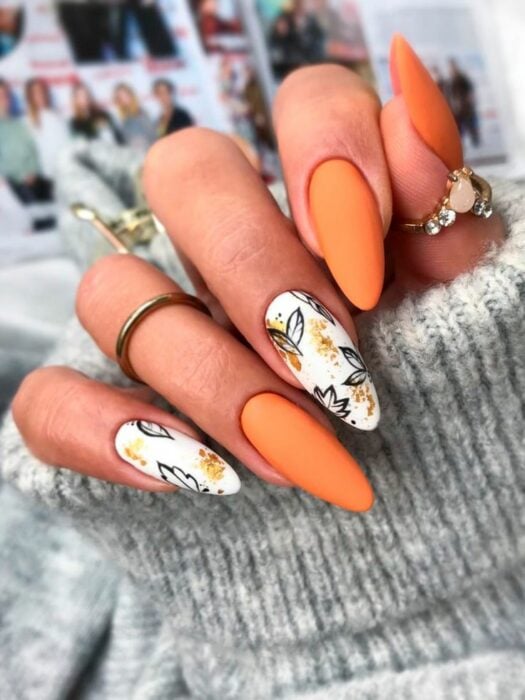 long acrylic nails in orange with autumn leaf design in others 