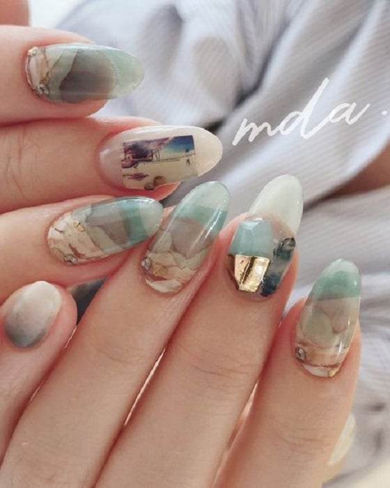 Manicure design in green and earth tones in crystal style