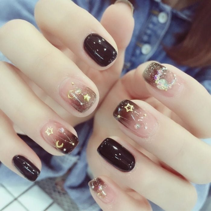 Manicure design in brown tones and with star figurines