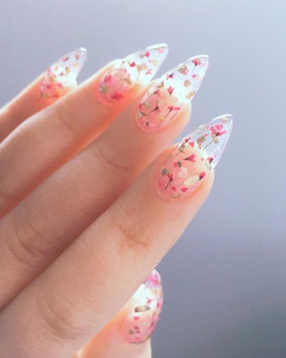 Manicure design on transparent background with flower figurines